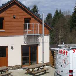 Fire evacuation ladder with access balcony Emergency evacuation ladder with access balcony on a one story cottage.
